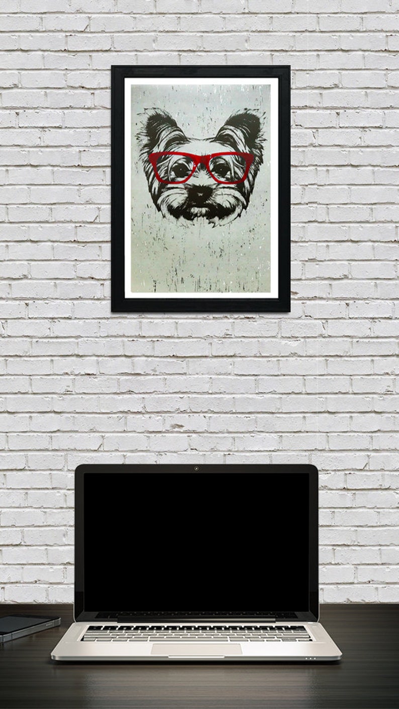 May include: A black and white illustration of a dog wearing red glasses. The dog is looking directly at the viewer. The illustration is on a white background and is framed in a black frame.