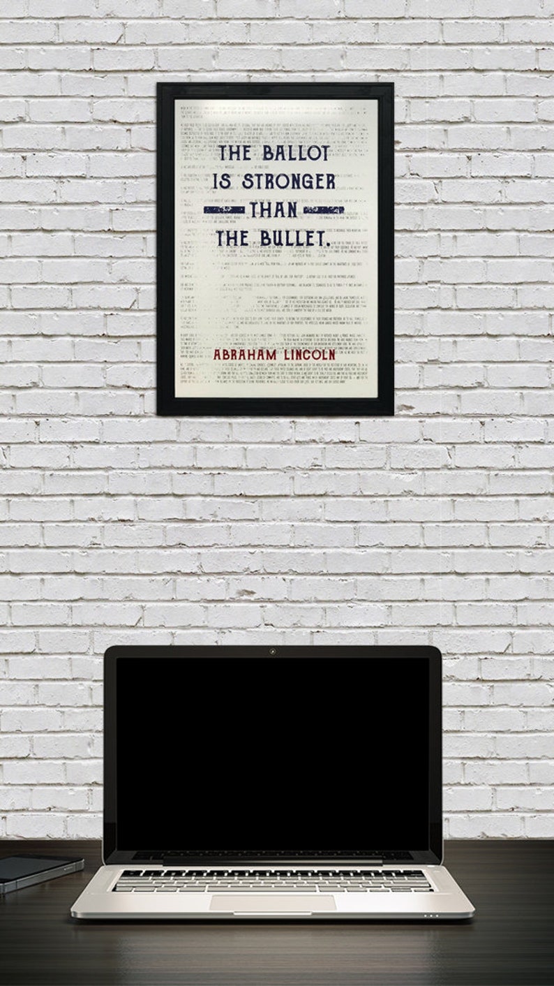May include: A framed print with a white background and black text that reads "The Ballot is Stronger Than The Bullet." The text is in a vintage style font. The quote is attributed to Abraham Lincoln at the bottom of the print.