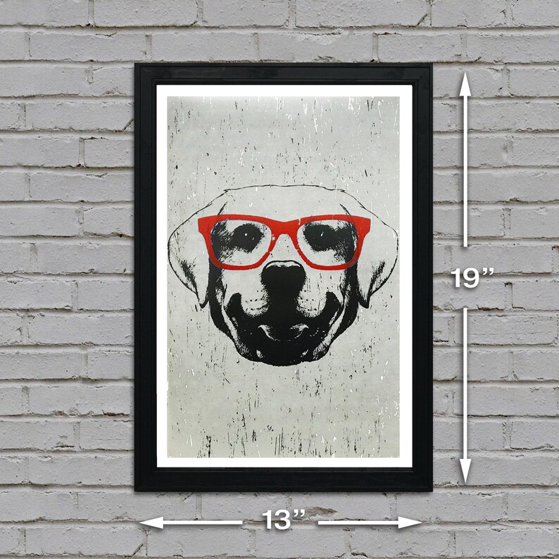 May include: A black and white illustration of a dog wearing red glasses. The image is printed on a white background with a distressed texture. The print is framed in a black frame with a white mount. The frame measures 13 inches wide by 19 inches tall.