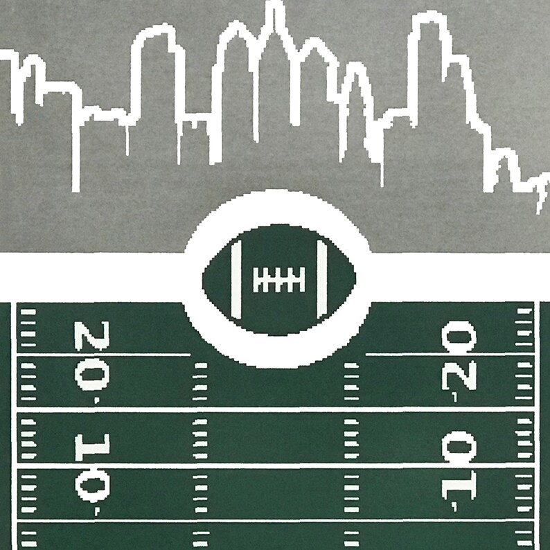 May include: A green and white football field with a white outline of a football in the center. The top of the image shows a white silhouette of a city skyline.