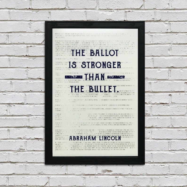 May include: A black framed print with a white background and blue text. The text reads "The ballot is stronger than the bullet. Abraham Lincoln."
