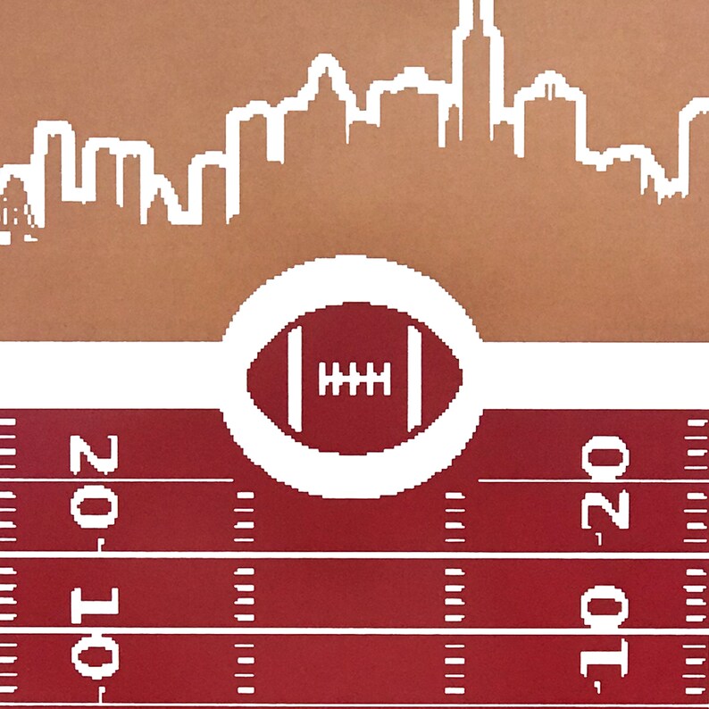 May include: A red and white football field with a white circle containing a football in the center. The top of the image shows a white silhouette of a city skyline against a brown background.