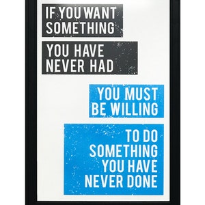 May include: A motivational quote in a black frame on a white background. The quote reads: "If you want something you have never had, you must be willing to do something you have never done."