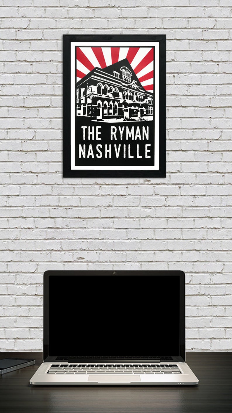 May include: Black and white illustration of the Ryman Auditorium in Nashville, Tennessee. The building is depicted with a red and white sunburst behind it. The text "THE RYMAN NASHVILLE" is below the building.