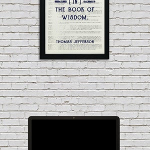 May include: A framed black and white print with a quote by Thomas Jefferson: "Honesty is the first chapter [in] the book of wisdom."