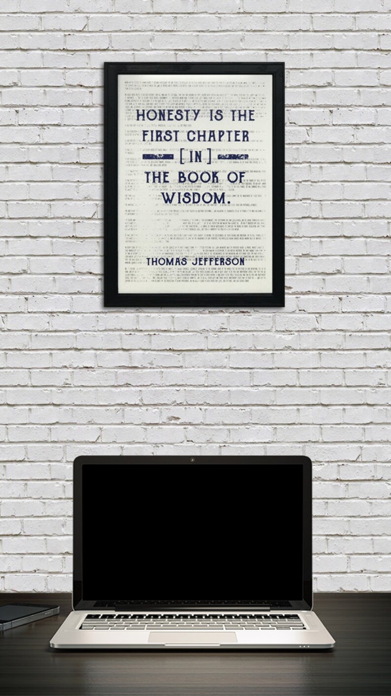 May include: A framed black and white print with a quote by Thomas Jefferson: "Honesty is the first chapter [in] the book of wisdom."