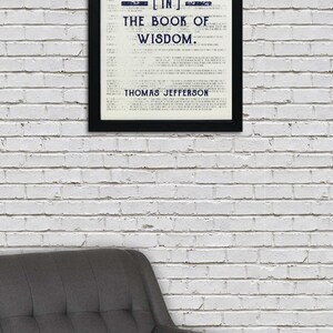 May include: A black framed print with a white background and blue text. The text reads "Honesty is the first chapter [in] the book of wisdom. Thomas Jefferson."