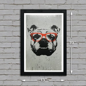 May include: A black framed print of a bulldog wearing red glasses. The print is 13 inches wide and 19 inches tall.