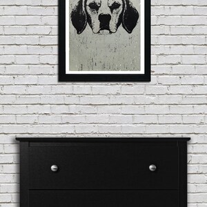 May include: Black and white illustration of a dog's head against a textured background. The dog has large floppy ears and a serious expression.