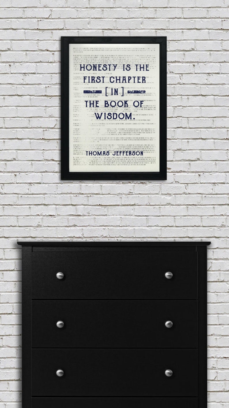 May include: A black framed print with a white background and blue text. The text reads "Honesty is the first chapter [in] the book of wisdom. Thomas Jefferson."