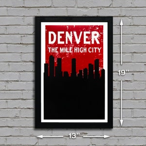 May include: Framed art print featuring the Denver skyline in black against a red background. The print includes the text "DENVER THE MILE HIGH CITY" in white. The framed print measures 19 inches high and 13 inches wide.