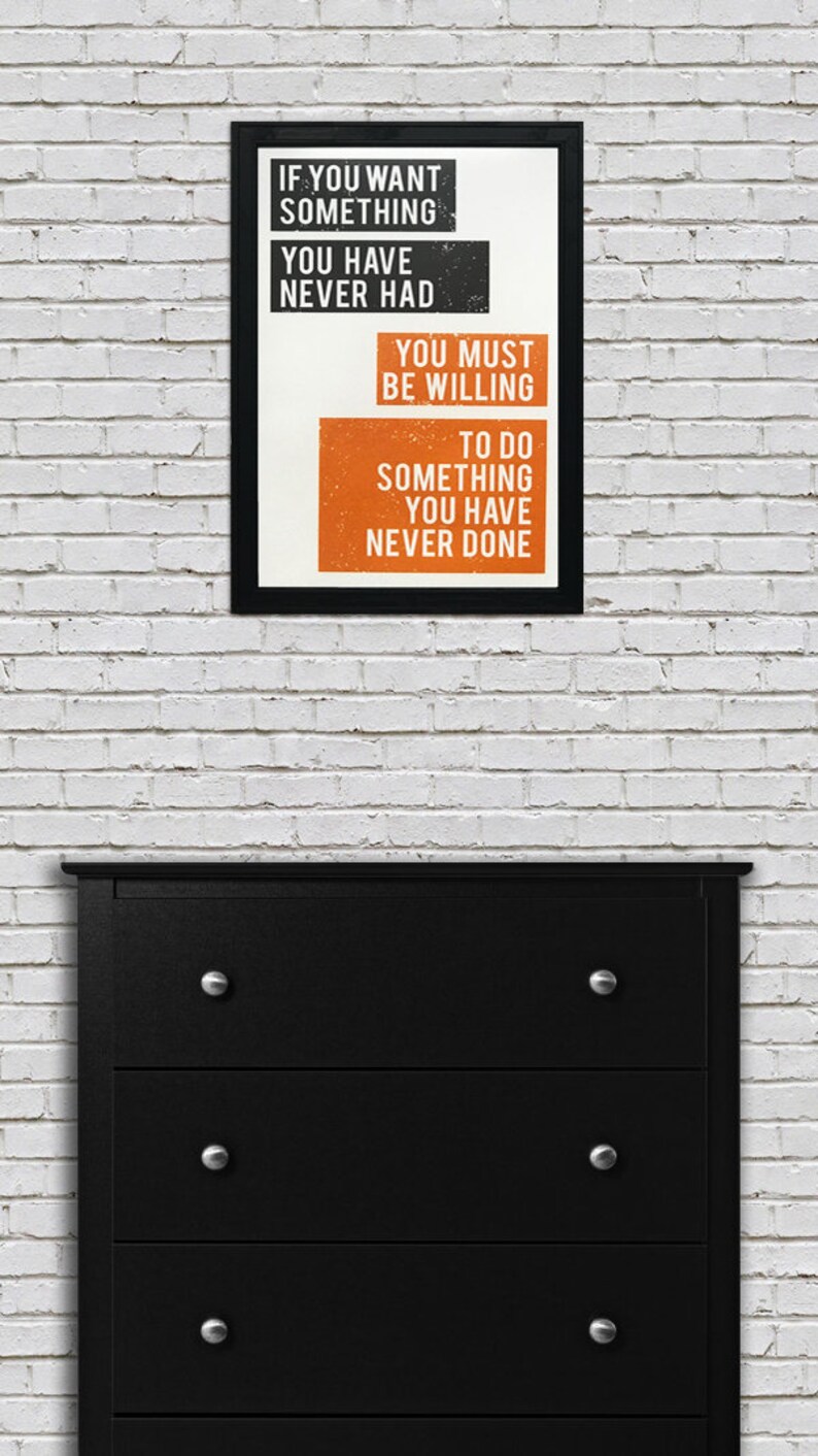 May include: Black framed motivational poster with white text on a white background. The text reads "If you want something you have never had you must be willing to do something you have never done."