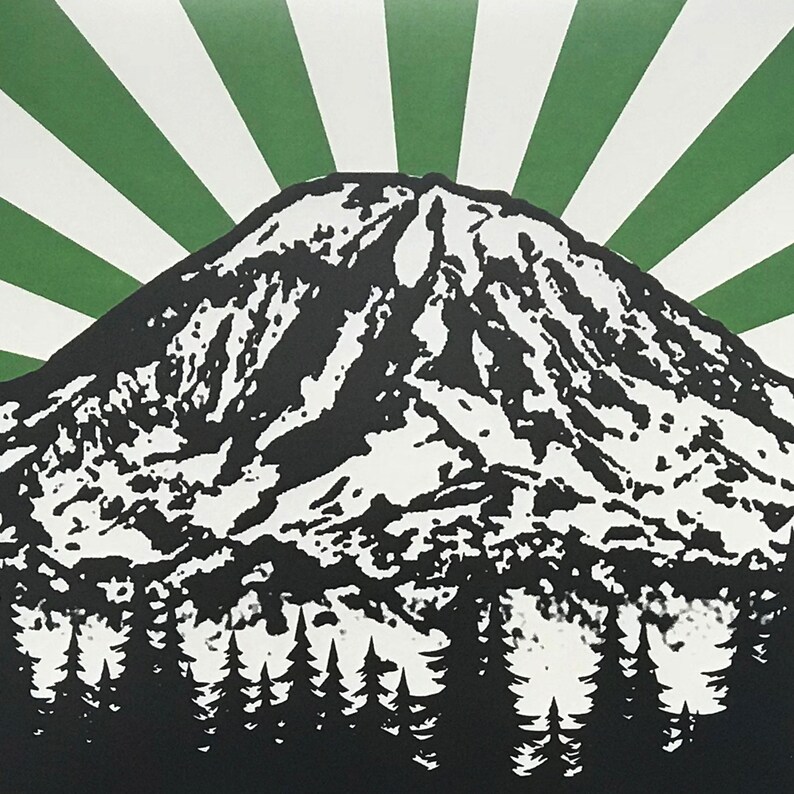 May include: A black and white illustration of a mountain with a green and white sunburst behind it. The mountain is covered in snow and has a forest of trees at the base.