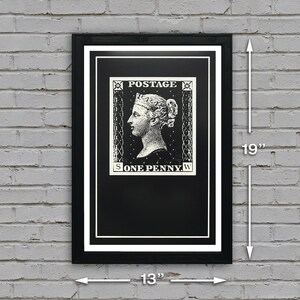 May include: A black and white framed print of a vintage postage stamp featuring a portrait of a woman with the text "POSTAGE ONE PENNY". The print measures 13 inches wide by 19 inches tall.