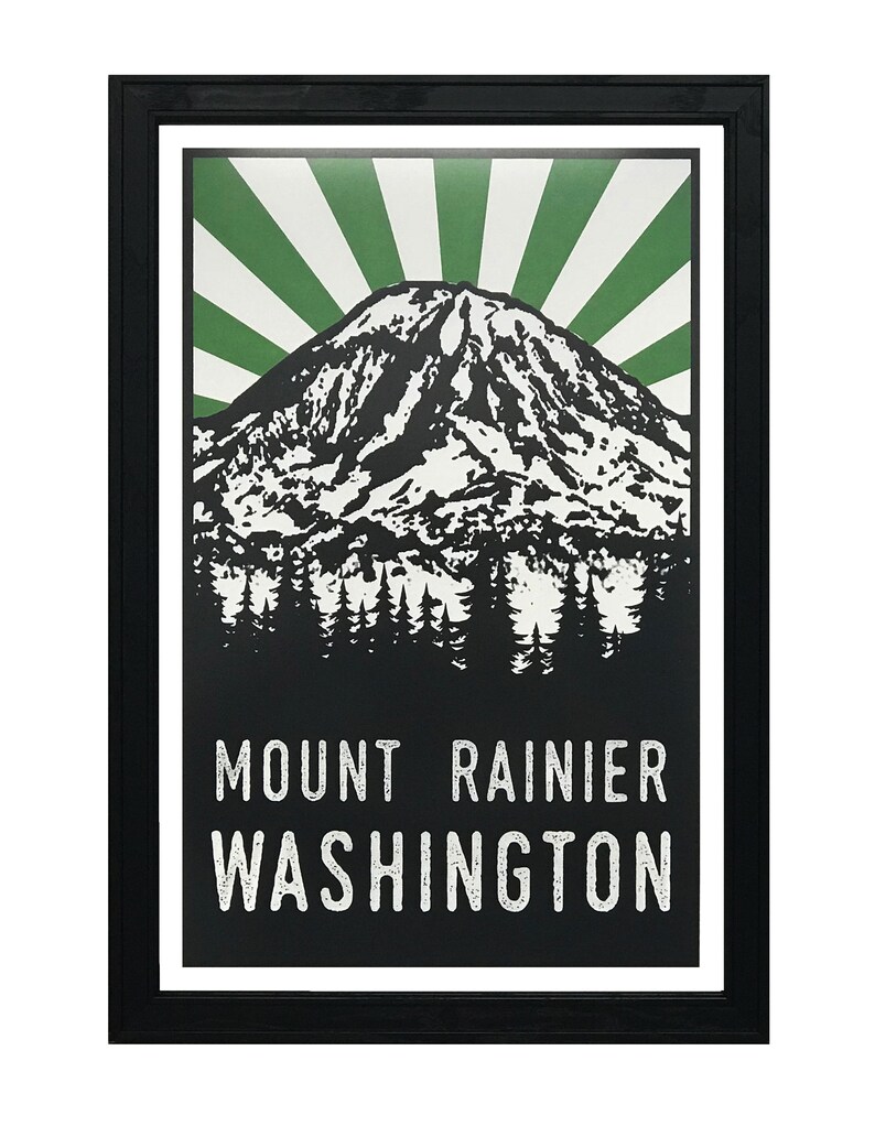May include: Black and white illustration of Mount Rainier with a green sunburst behind it. The text "MOUNT RAINIER WASHINGTON" is below the mountain.
