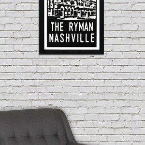May include: Black and white illustration of the Ryman Auditorium in Nashville, Tennessee. The building is depicted with a red and white sunburst behind it. The text "The Ryman Nashville" is printed below the building.