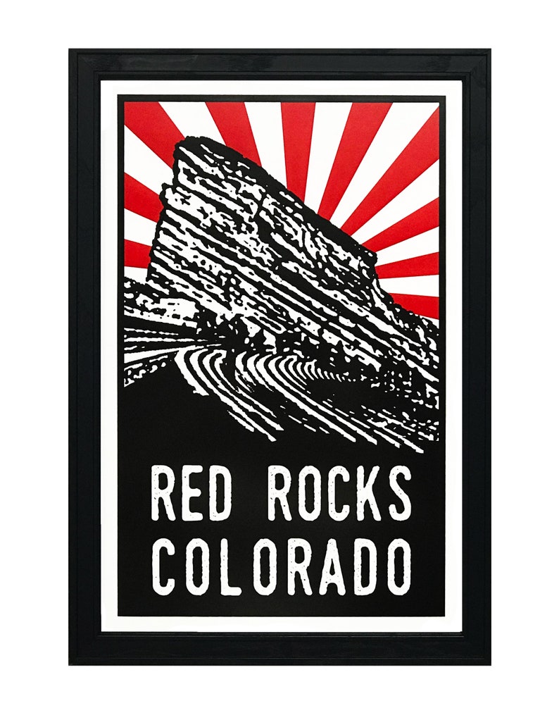 May include: Black and white illustration of Red Rocks Amphitheatre in Morrison, Colorado, with a red and white sunburst behind it. The text "RED ROCKS COLORADO" is below the illustration.