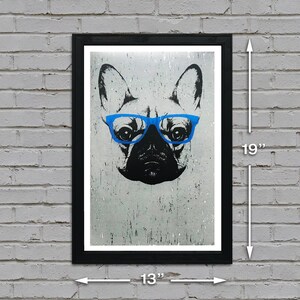May include: A black framed print of a French Bulldog wearing blue glasses. The print is 13 inches wide and 19 inches tall.