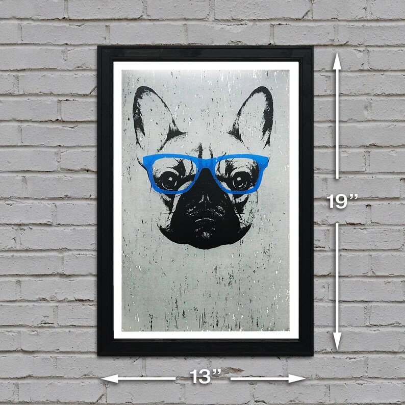 May include: A black framed print of a French Bulldog wearing blue glasses. The print is 13 inches wide and 19 inches tall.