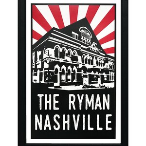 May include: Black and white illustration of the Ryman Auditorium in Nashville, Tennessee. The building is depicted in a vintage style with a red and white sunburst behind it. The text "The Ryman Nashville" is printed below the building.