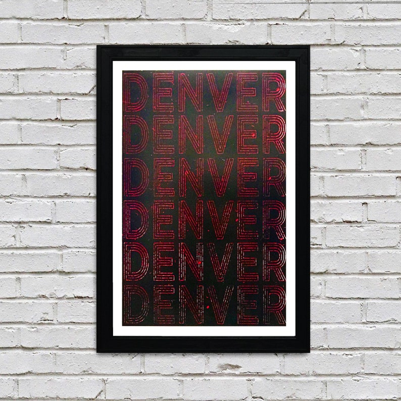 May include: A framed print with the word "DENVER" repeated six times in a red, layered font on a black background.
