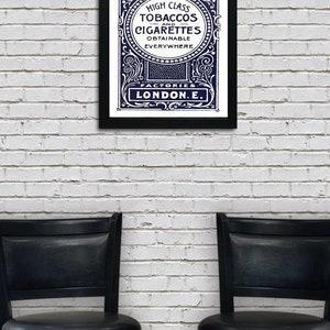 May include: A vintage advertisement for Harris & Sons high class tobaccos and cigarettes, printed in black and white with a blue background. The text reads "High Class Tobaccos and Cigarettes Obtainable Everywhere Factories London E."