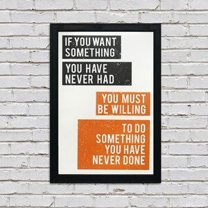May include: A motivational quote poster with black and orange text on a white background. The quote reads: "If you want something you have never had, you must be willing to do something you have never done."