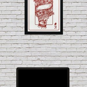 May include: A framed print of a playing card featuring a red illustration of the King of Diamonds. The King is depicted as a skeleton wearing a crown and a ruff collar. The card is surrounded by a black frame.