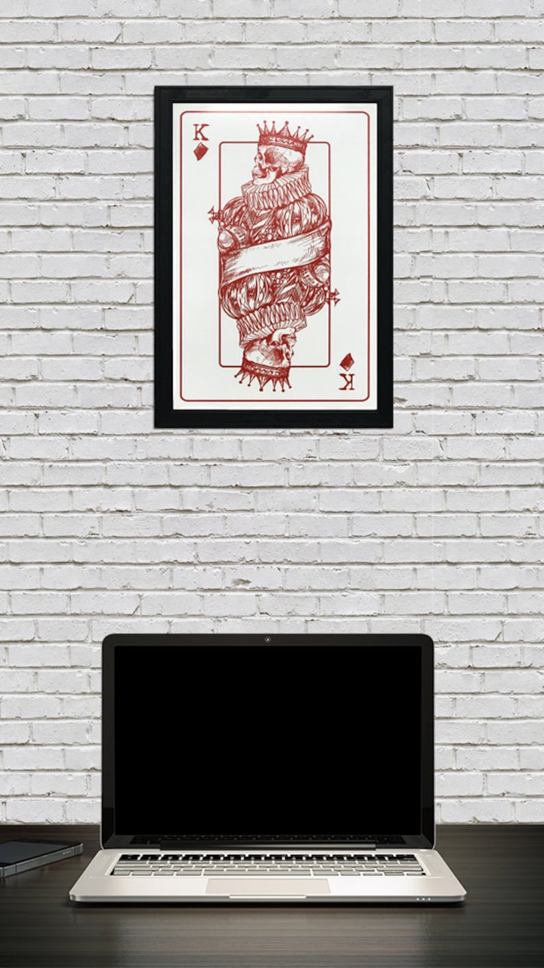 May include: A framed print of a playing card featuring a red illustration of the King of Diamonds. The King is depicted as a skeleton wearing a crown and a ruff collar. The card is surrounded by a black frame.