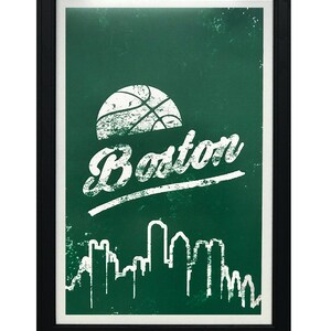 May include: A framed green and white poster with a basketball, the word "Boston" and a skyline of buildings.