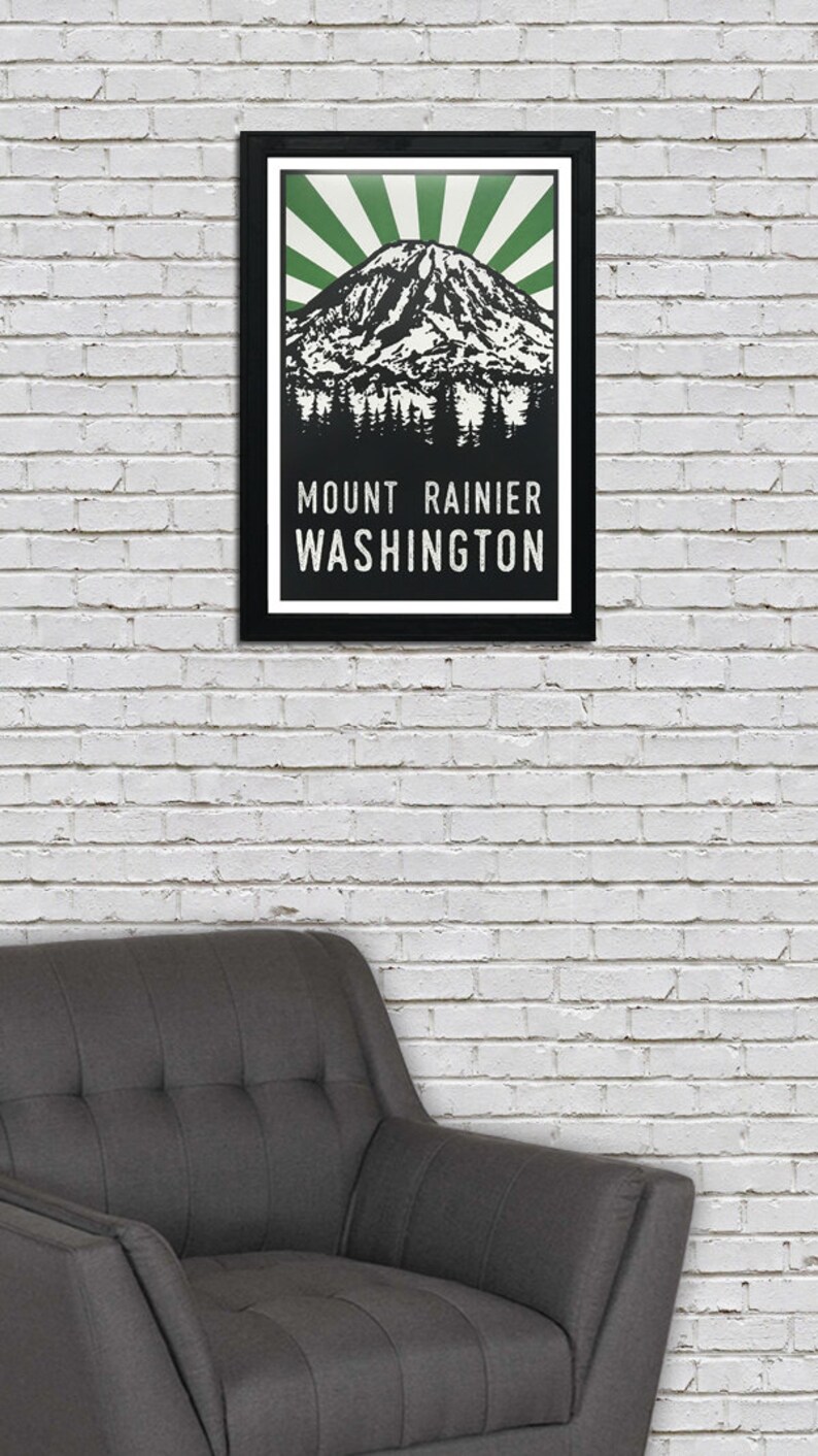 May include: A black framed poster with a green and white illustration of Mount Rainier, Washington. The text "MOUNT RAINIER WASHINGTON" is printed in white on a black background.