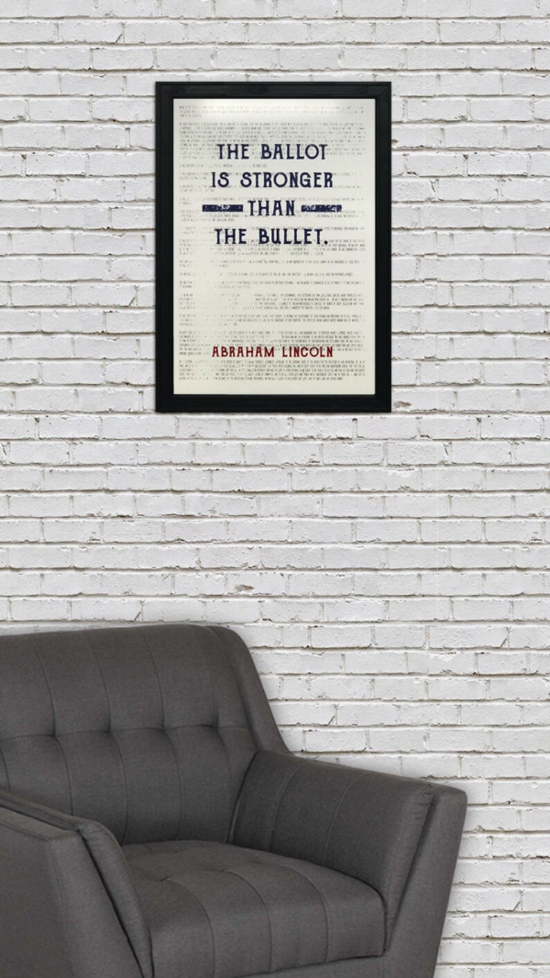 May include: A black framed print with a white background and black text that reads "The Ballot is Stronger Than The Bullet."  The text is in a vintage style font.  The quote is attributed to Abraham Lincoln at the bottom of the print.