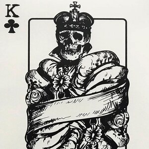 May include: Black and white illustration of the King of Clubs playing card. The King is depicted as a skull wearing a crown and a robe. The card is surrounded by a white border.