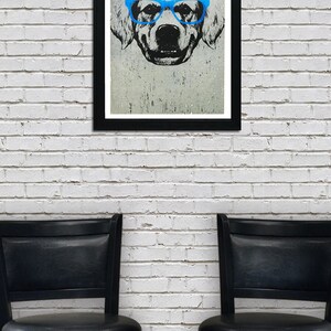 May include: A framed black and white illustration of a dog wearing blue glasses. The dog is looking directly at the viewer. The image is on a white brick wall with two black bar stools in front of it.