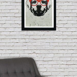 May include: A black and white illustration of a dog wearing red glasses. The dog is looking directly at the viewer. The illustration is framed in a black frame.