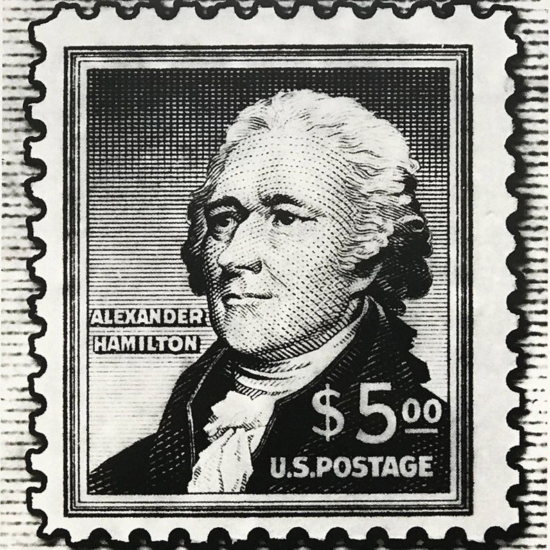 May include: Black and white stamp featuring a portrait of Alexander Hamilton with the text "ALEXANDER HAMILTON" and "$5.00 U.S. POSTAGE".