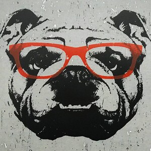 May include: A black and white illustration of a bulldog wearing red-rimmed glasses. The bulldog has a serious expression and its mouth is slightly open.