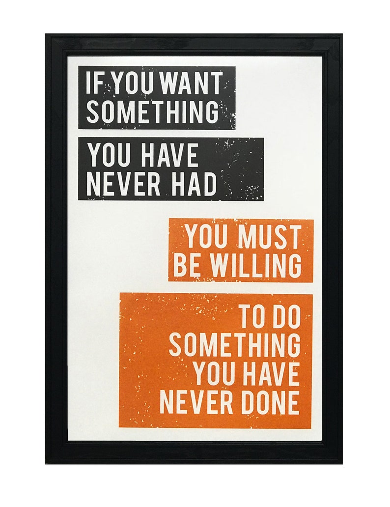 May include: Black framed motivational poster with white text on a white background. The text reads "If you want something you have never had you must be willing to do something you have never done."