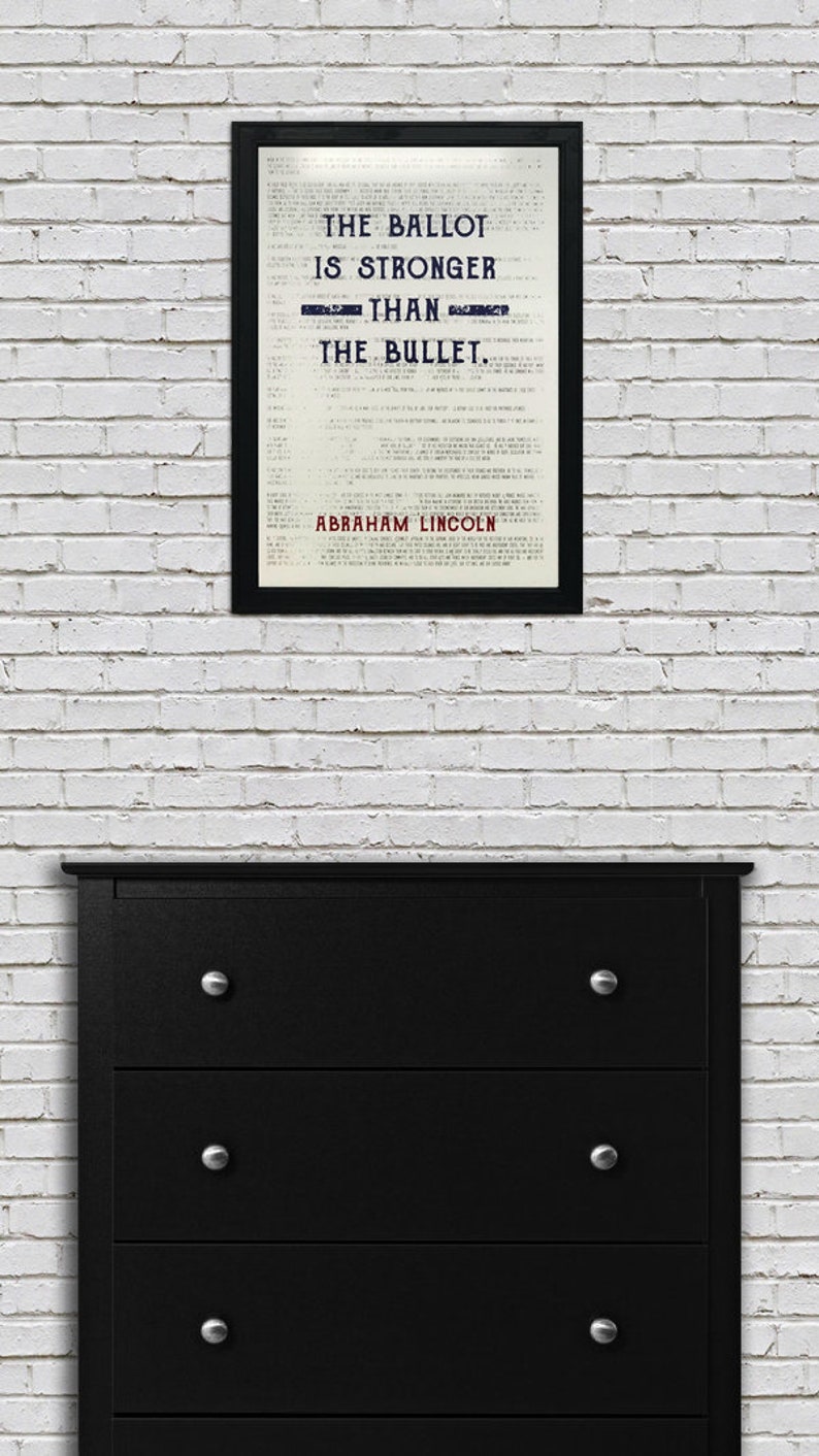 May include: A black framed print with a white background and black text that reads "The Ballot is Stronger Than The Bullet." The text is in a vintage font. The name "Abraham Lincoln" is printed in red at the bottom of the print.