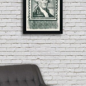 May include: A framed black and white print of a vintage US postage stamp featuring George Washington. The stamp is green and has the text "1&cent; U.S. POSTAGE" and "WASHINGTON".
