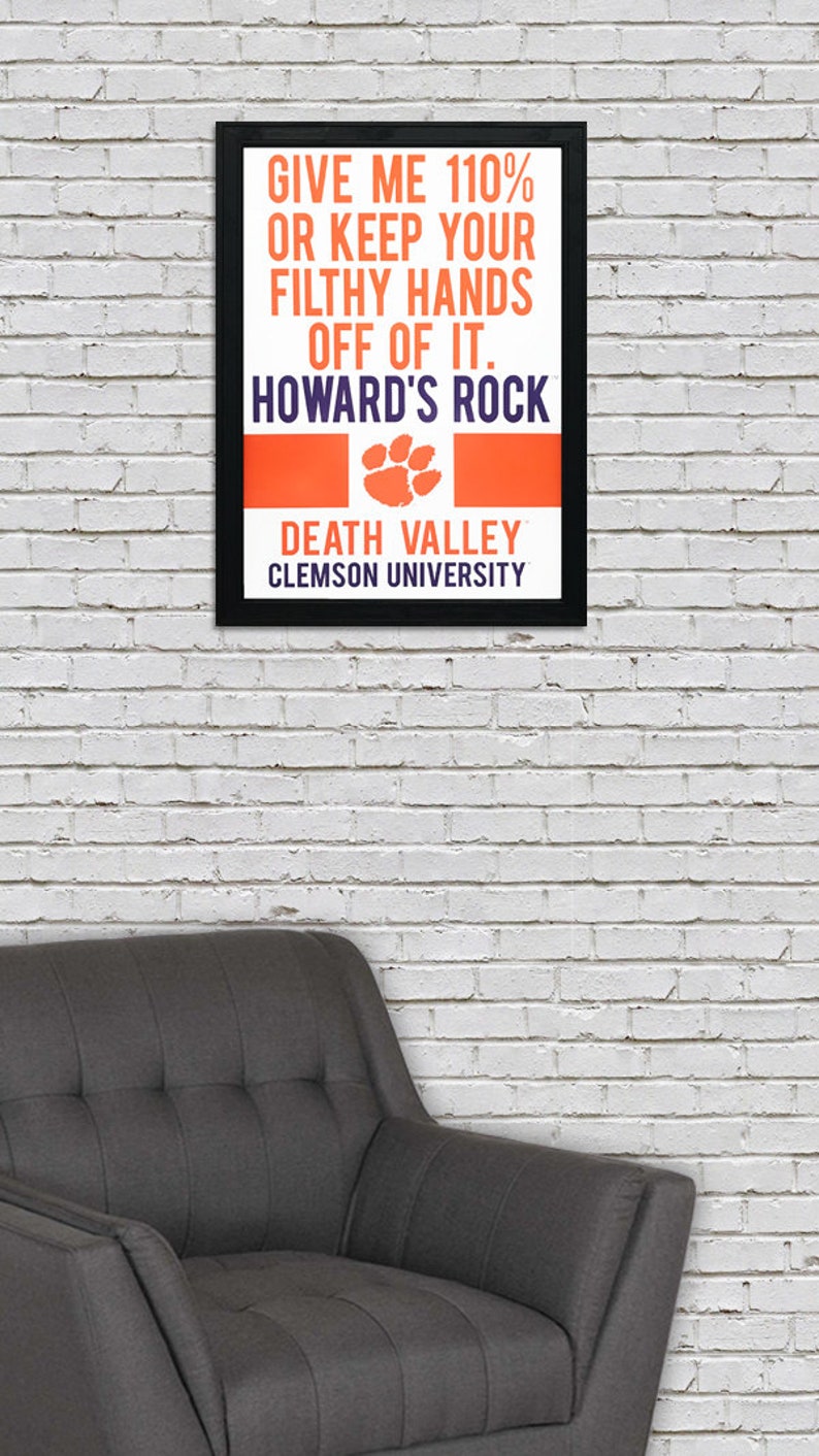 May include: A black framed poster with the text "Give me 110% or keep your filthy hands off of it. Howard's Rock. Death Valley. Clemson University." The poster has an orange and purple paw print.