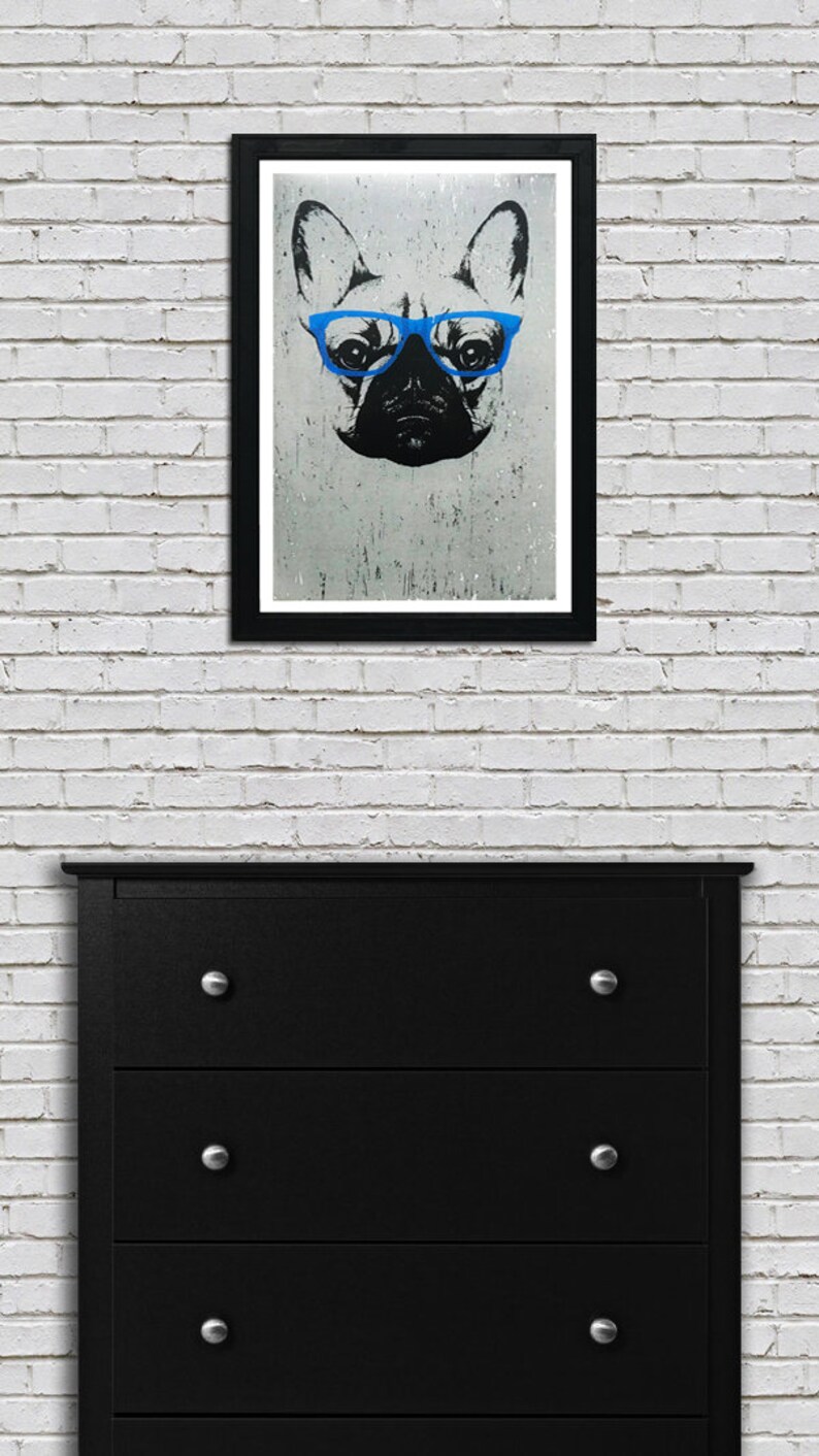 May include: A black and white illustration of a French bulldog wearing blue glasses. The image is printed on a textured background and framed in a black frame.
