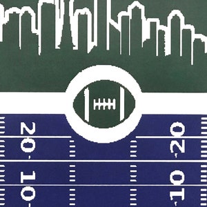 May include: A green and white football-themed graphic with a white outline of a city skyline at the top. The football is in a white circle with a green background. The bottom of the graphic is a blue football field with white yard lines and the numbers "20, 10" on the left side and "10, 20" on the right side.