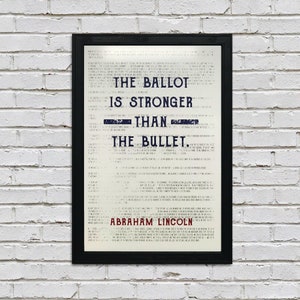 May include: A black framed print with a white background and blue text. The text reads "The ballot is stronger than the bullet. Abraham Lincoln".