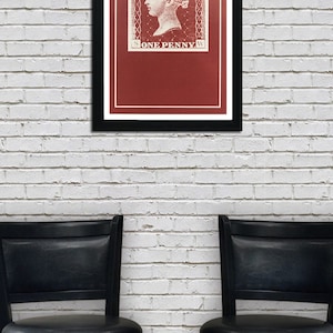 May include: A framed print of a vintage postage stamp featuring a portrait of Queen Victoria with the text "POSTAGE" and "ONE PENNY" in a red and white color scheme.