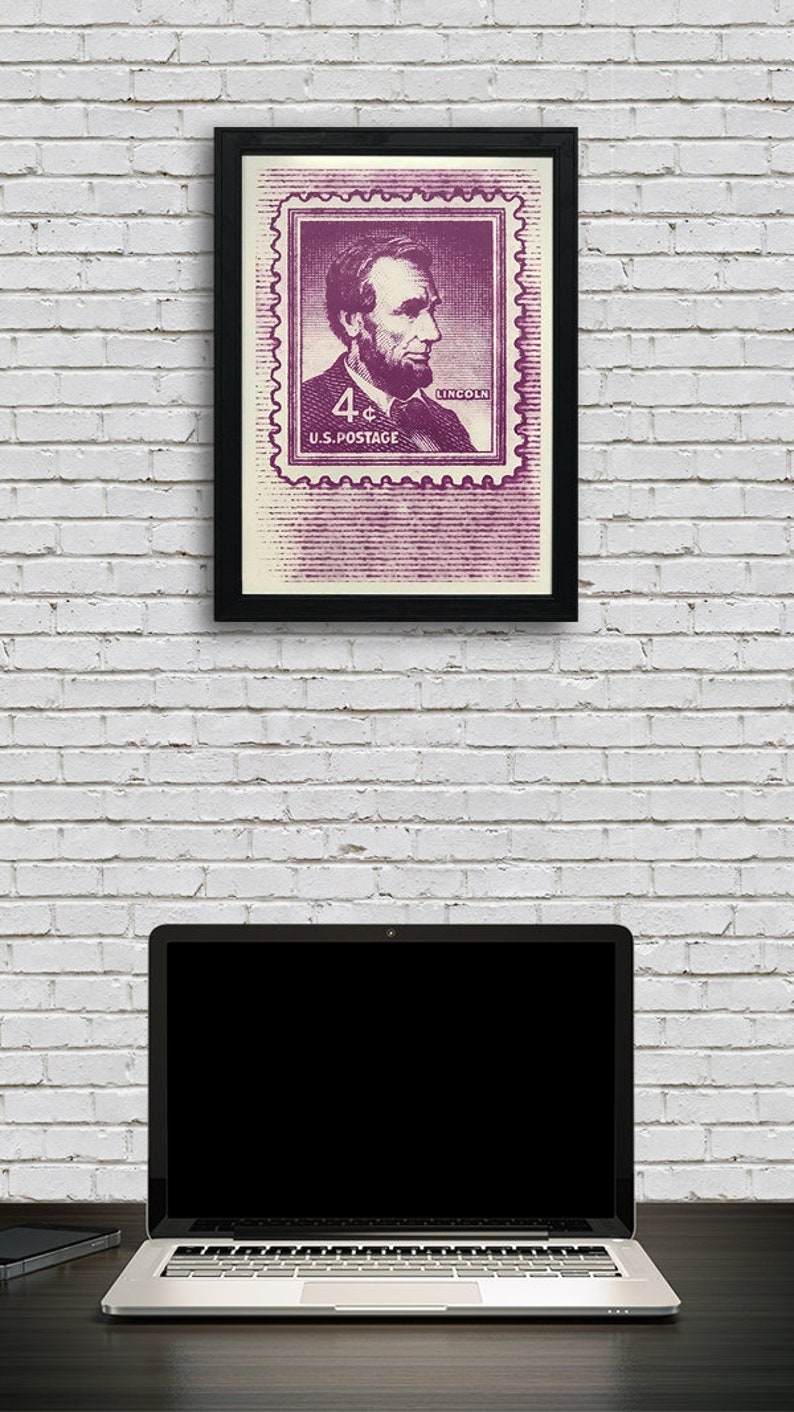 May include: A framed print of a vintage 4&cent; US postage stamp featuring a portrait of Abraham Lincoln. The stamp is in shades of purple and white with the text "4&cent; U.S. POSTAGE" and "LINCOLN".