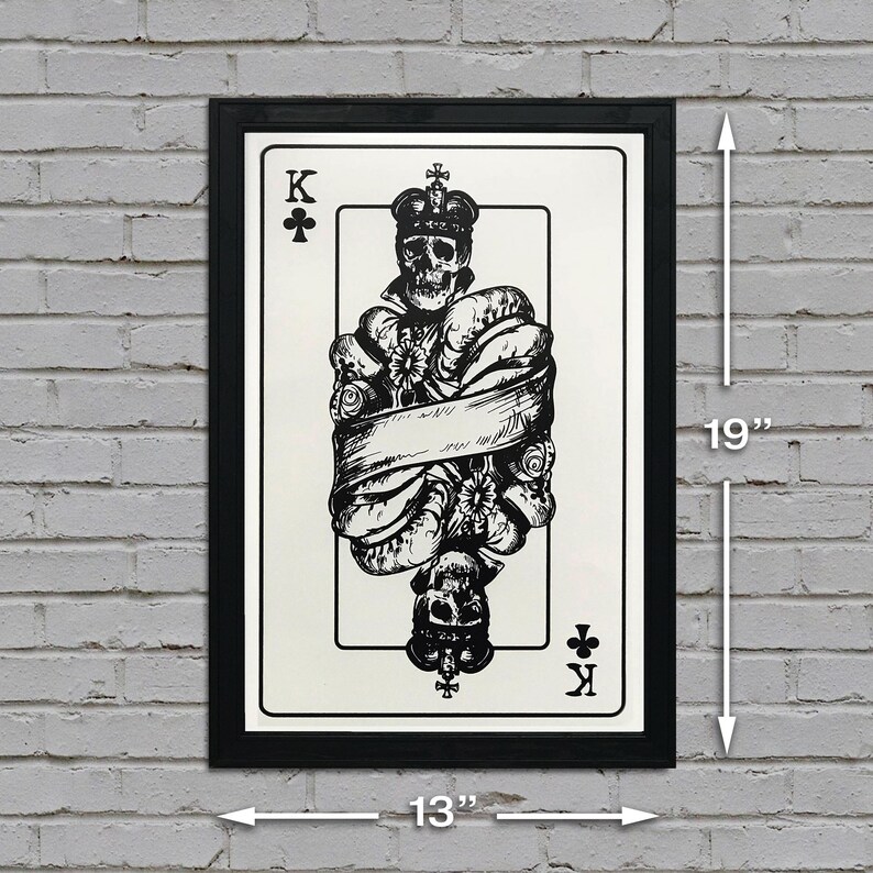 May include: Black and white illustration of the King of Clubs playing card featuring a skull wearing a crown and surrounded by flowers and a banner. The card is framed in a black frame and measures 13 inches wide by 19 inches tall.
