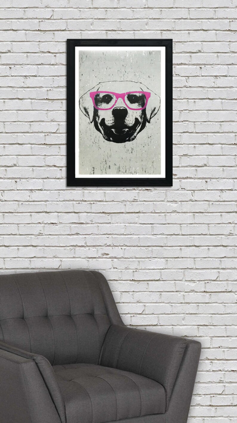 May include: A black and white illustration of a dog wearing pink glasses. The dog is looking directly at the viewer. The illustration is framed in a black frame.
