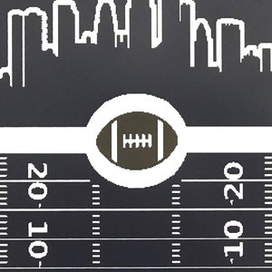 May include: A black and white illustration of a city skyline with a football in a white circle on a black and white football field. The field has yard lines marked with the numbers 10 and 20.