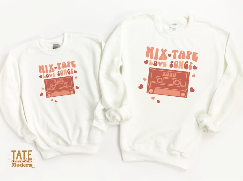 May include: Two white sweatshirts with a retro cassette tape graphic and the text "Mix-Tape Love Songs" in pink and orange. The text "XOXO" is on the cassette tape.